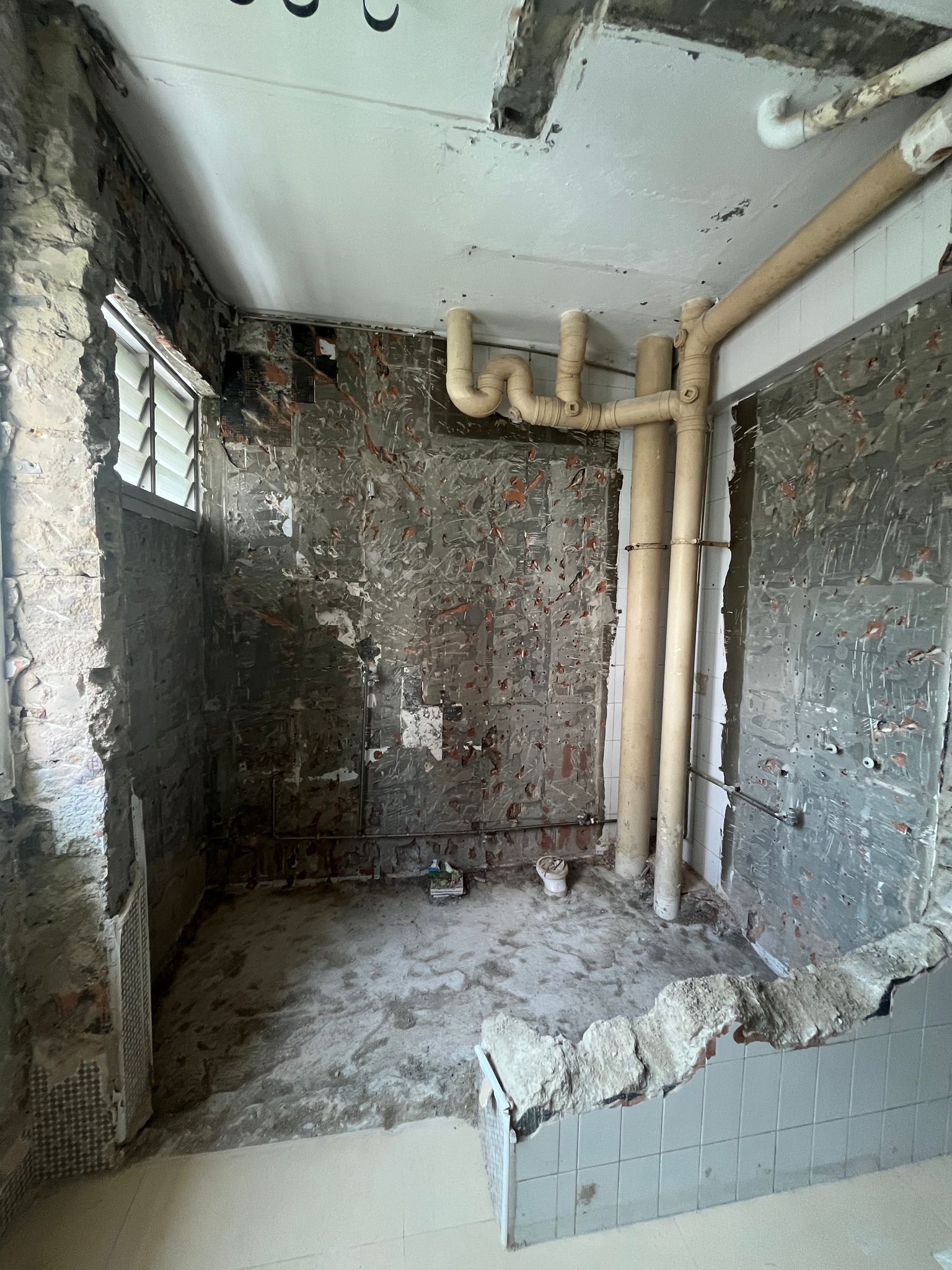 Bathroom with large drainage or sewer pipes