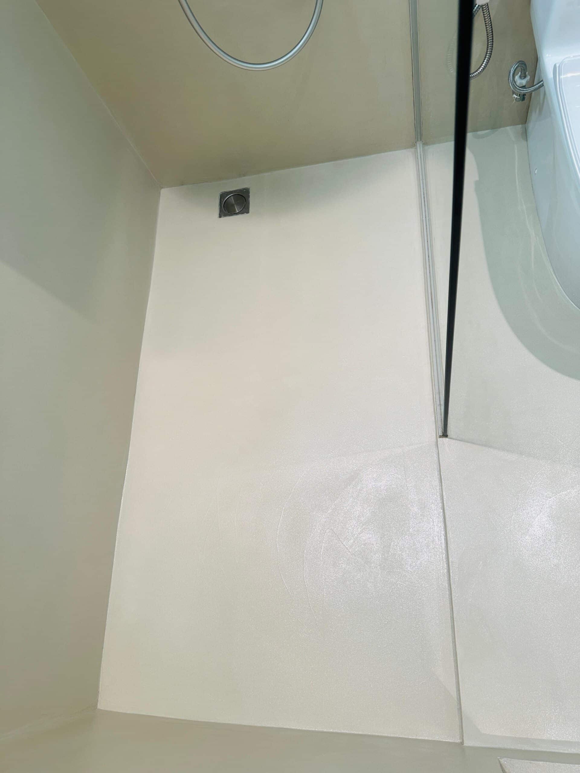 A mouldy bathroom floor after overlay